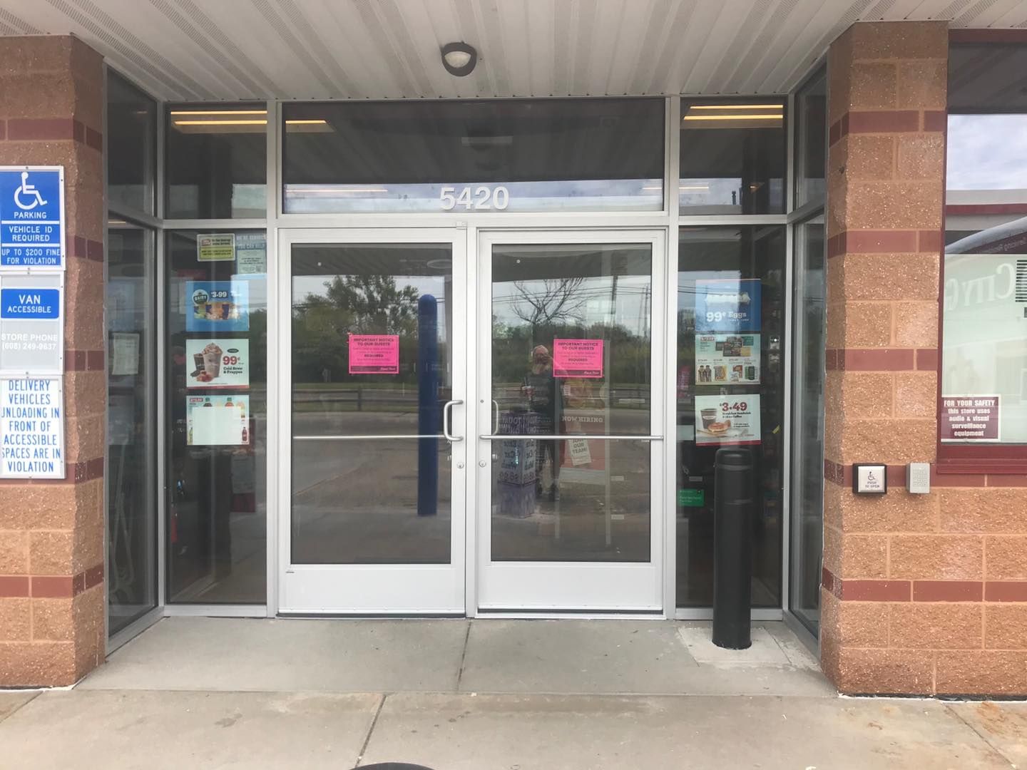 The front door of a building with a handicapped sign on it.