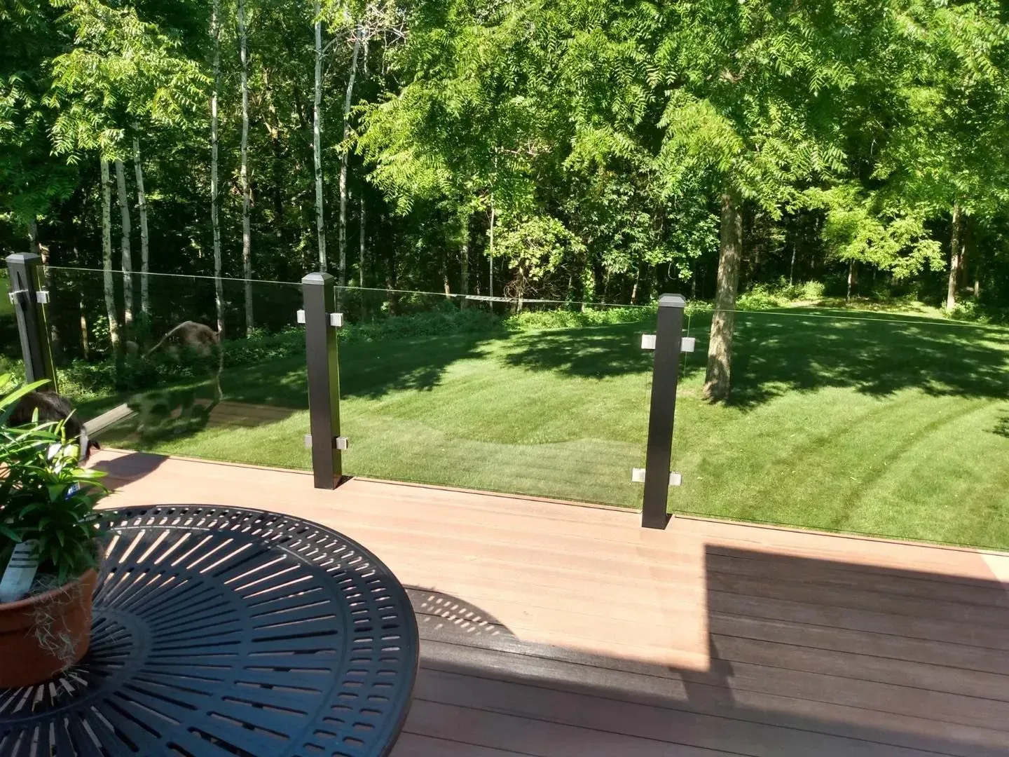 A view of a lush green field from a deck