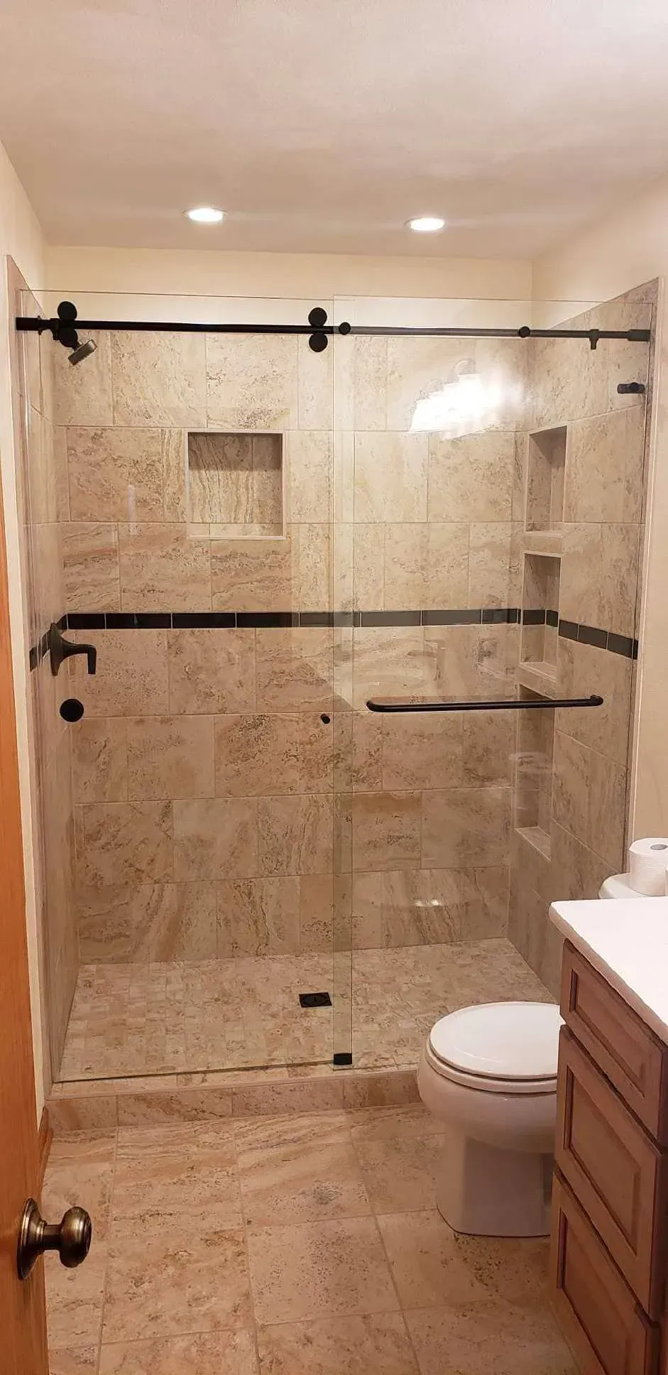 A bathroom with a walk in shower and a toilet.