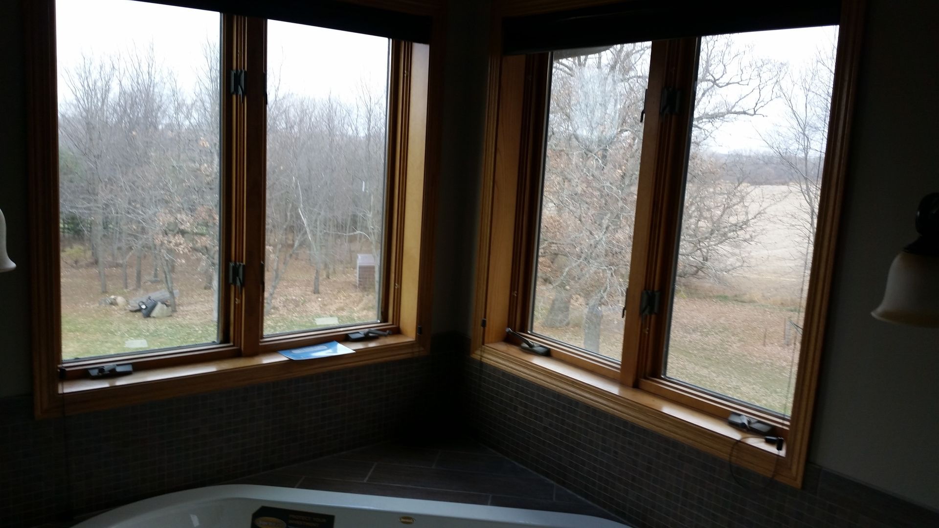 A bathroom with a jacuzzi tub and three windows
