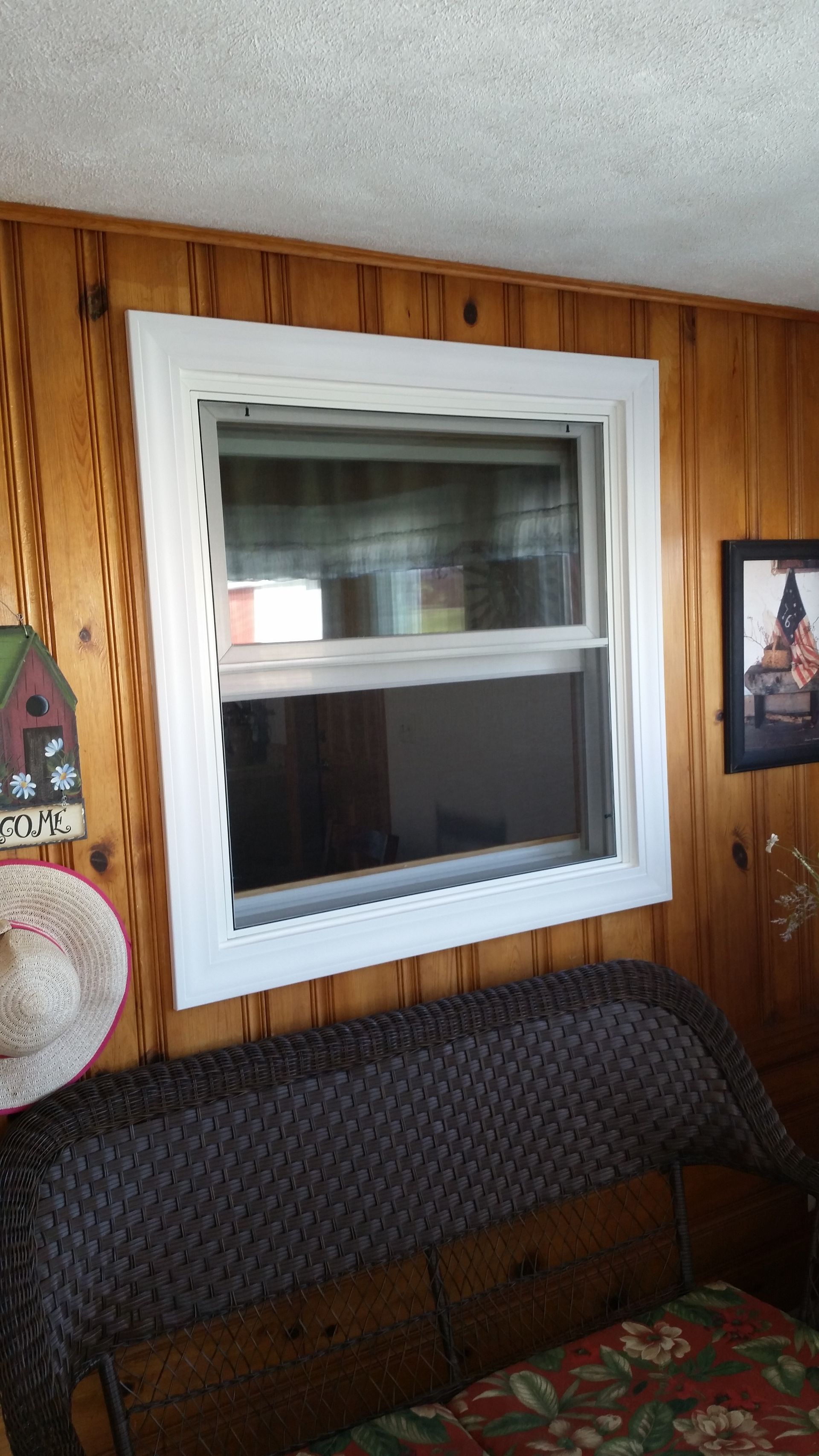 A living room with a window and a couch.
