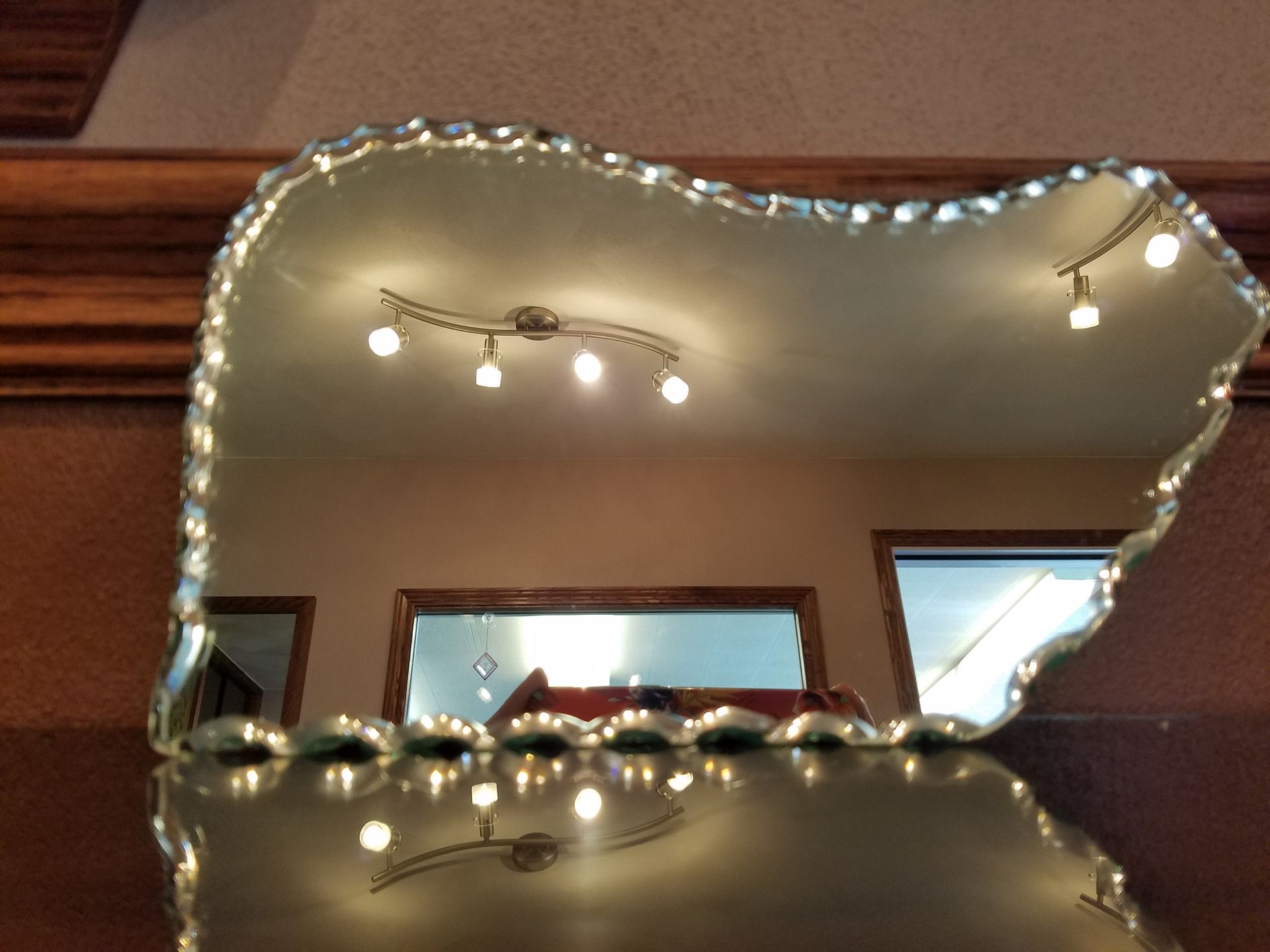 A heart shaped mirror with lights reflected in it