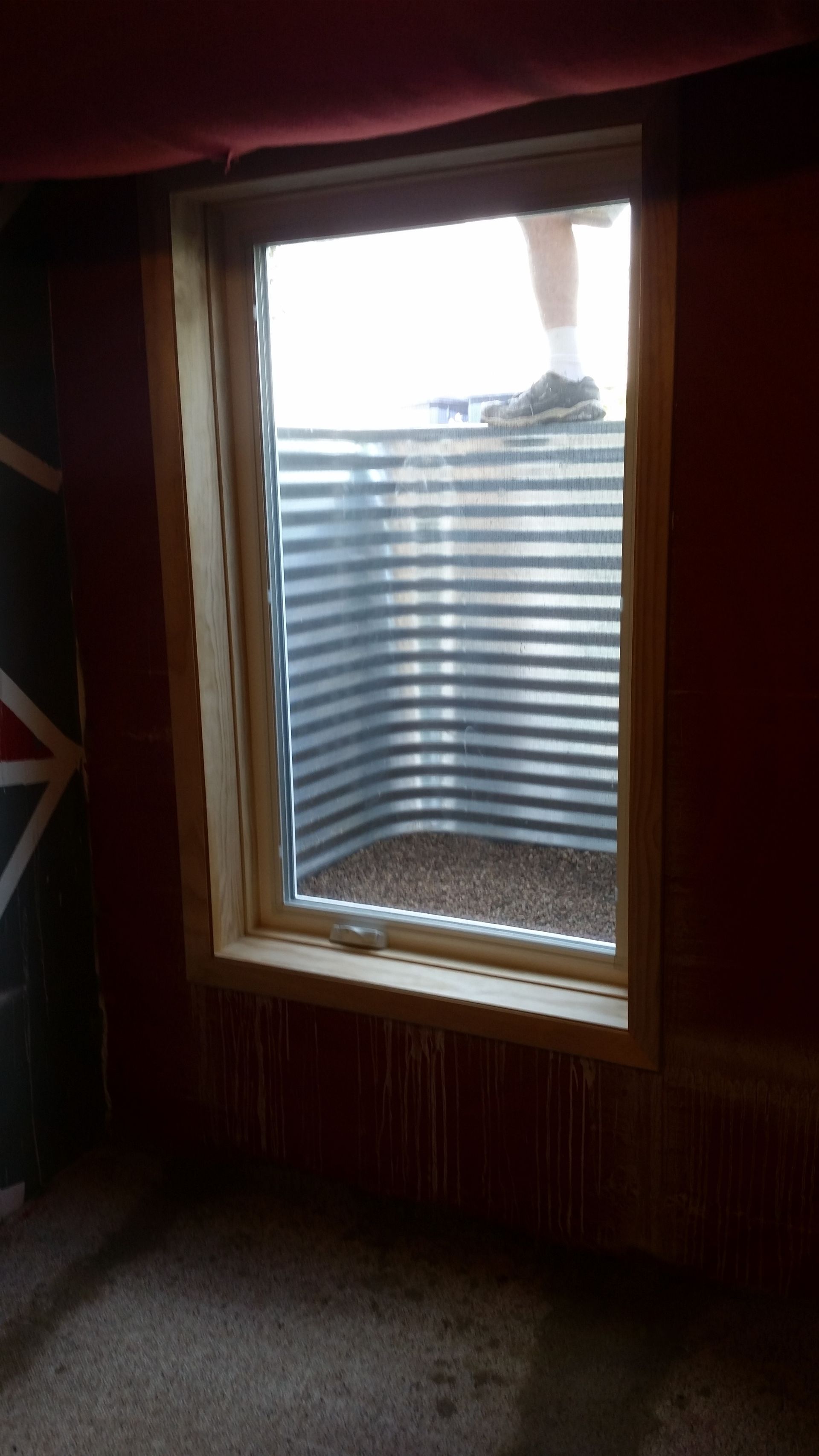 A window in a room with a british flag on the wall