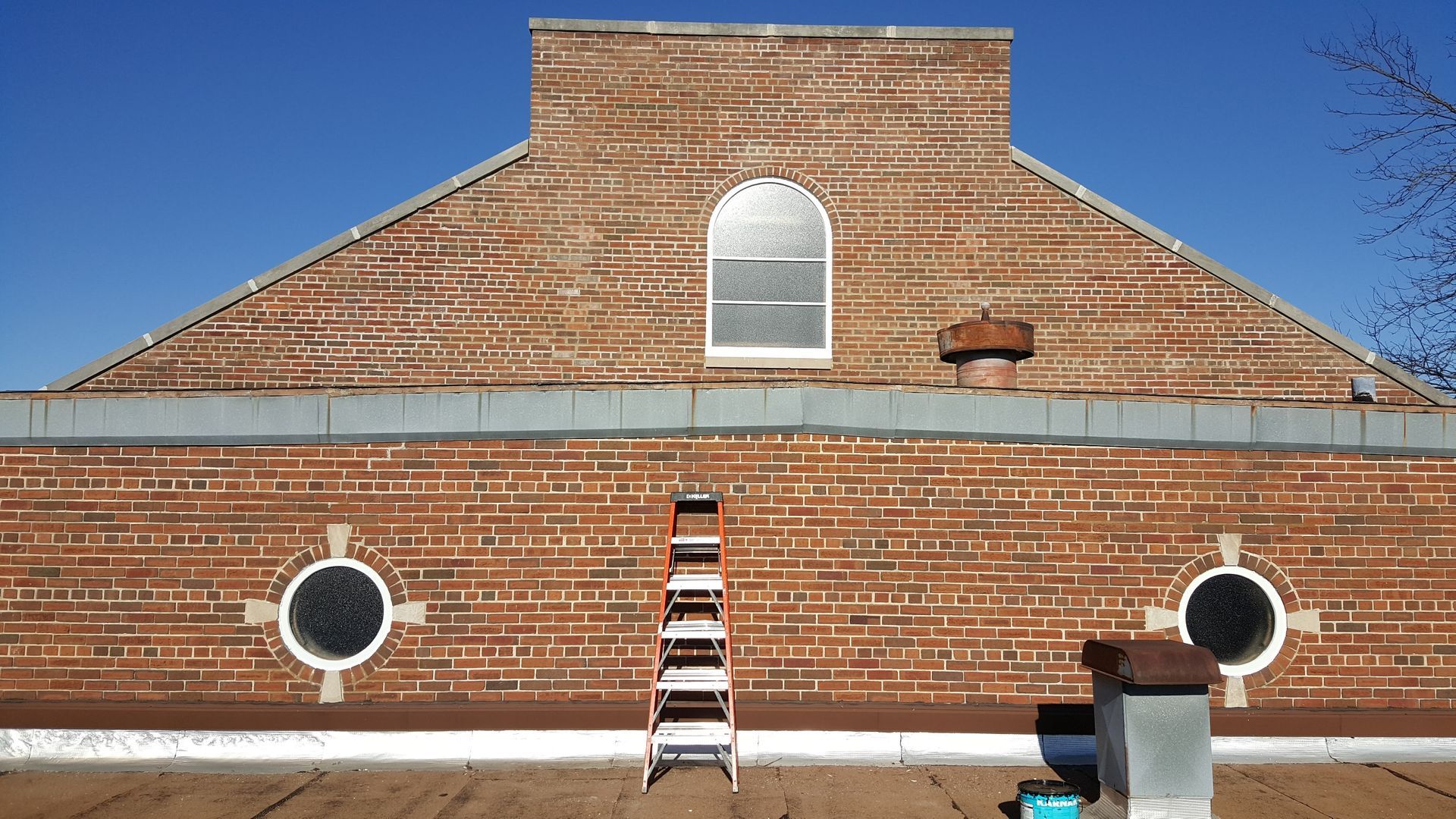 A brick building with a ladder on the side of it