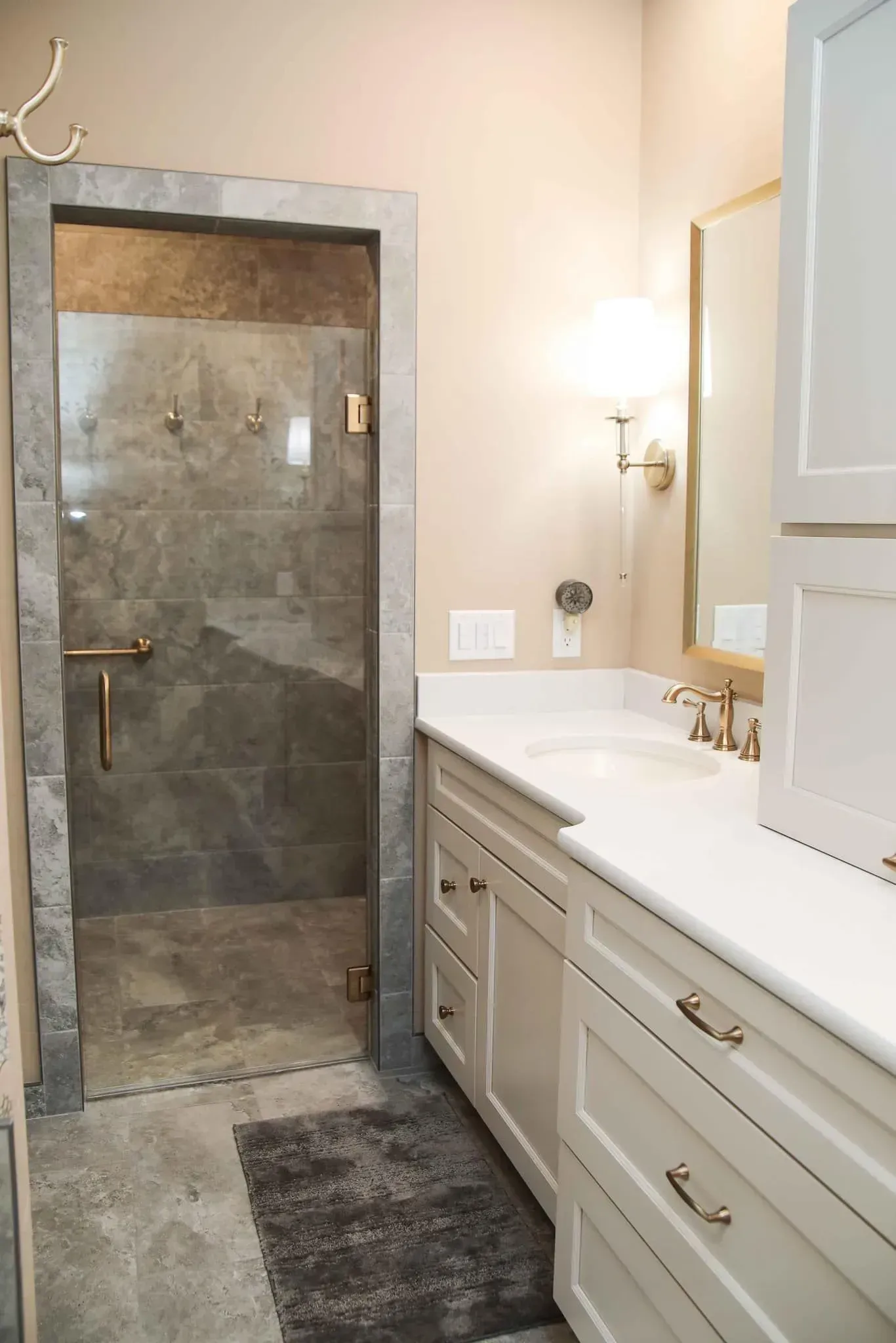 A bathroom with two sinks and a walk in shower.
