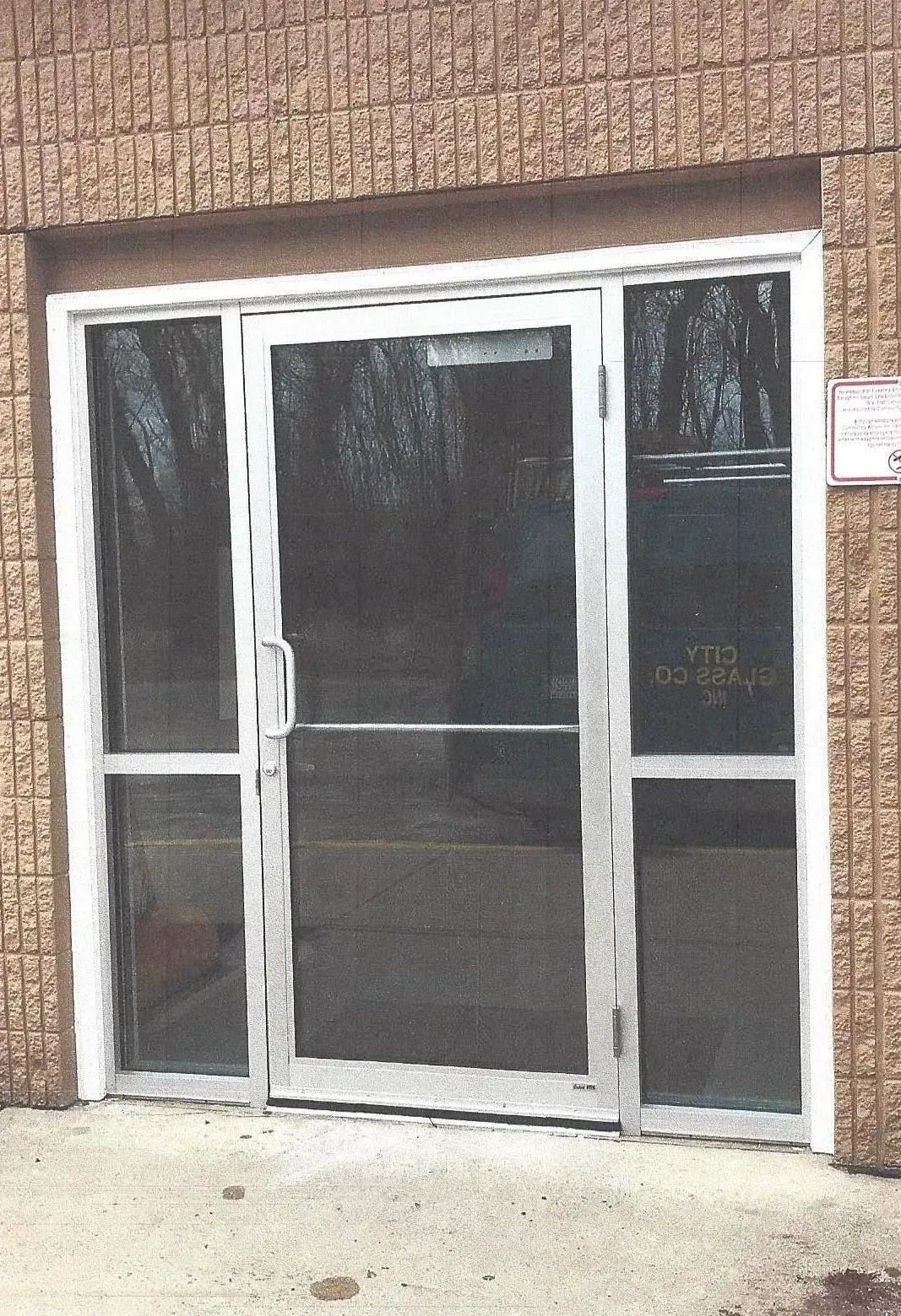 A brick building with a glass door and a sign that says vip
