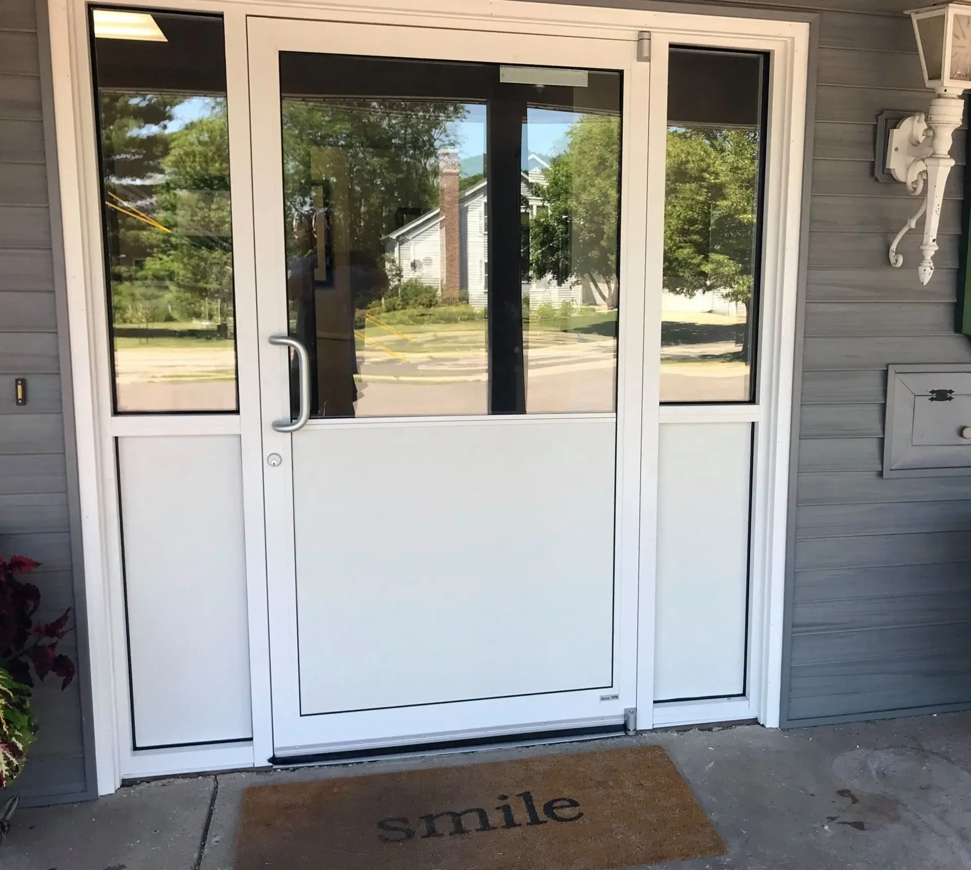 A door with a mat that says smile on it