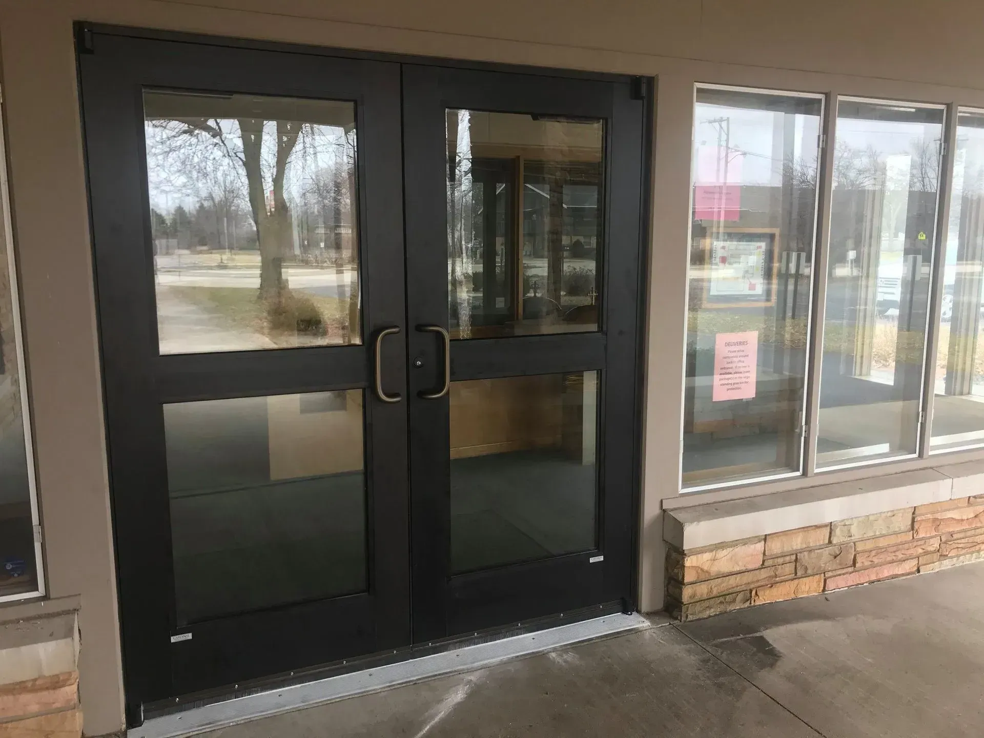 A building with a lot of windows and a black door.