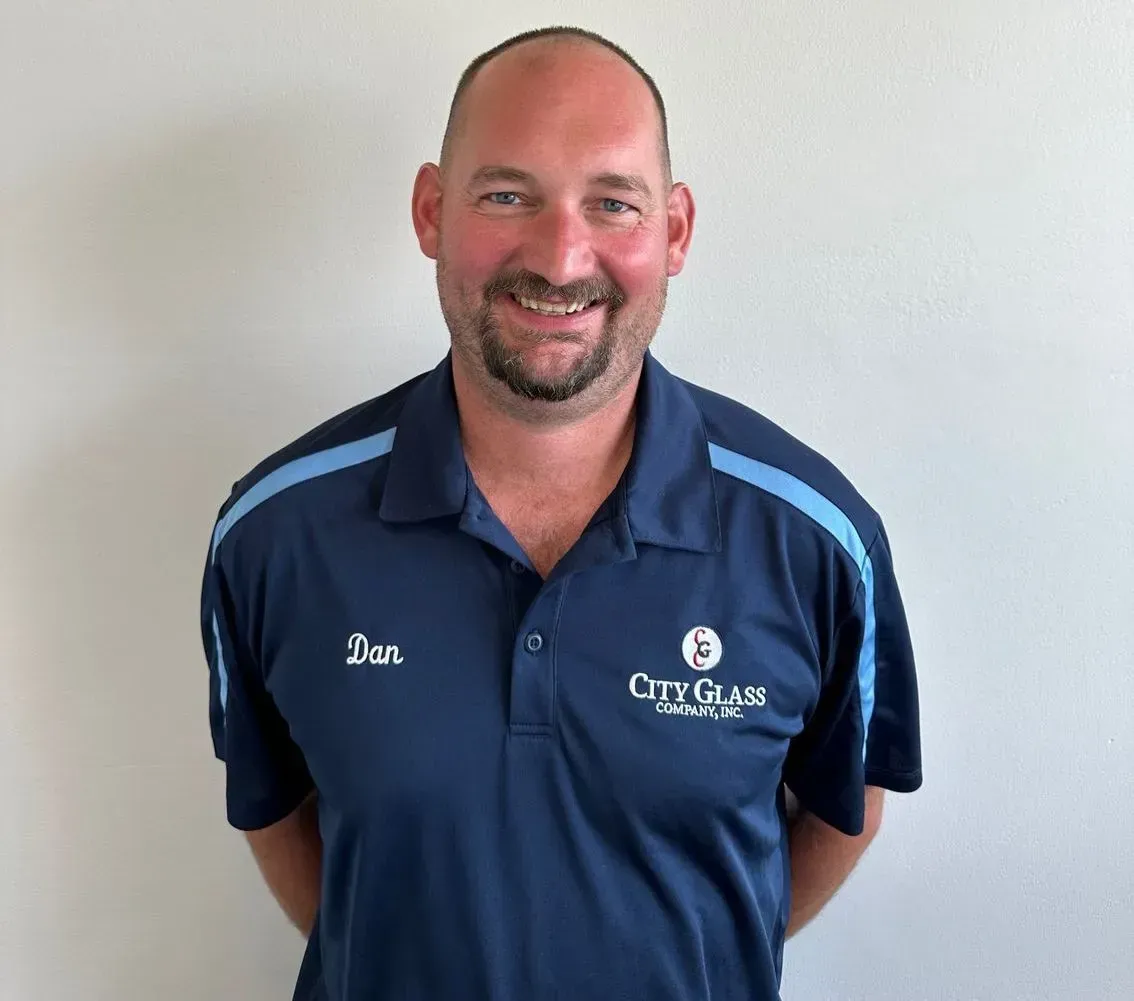 A man wearing a blue shirt with the word city on it