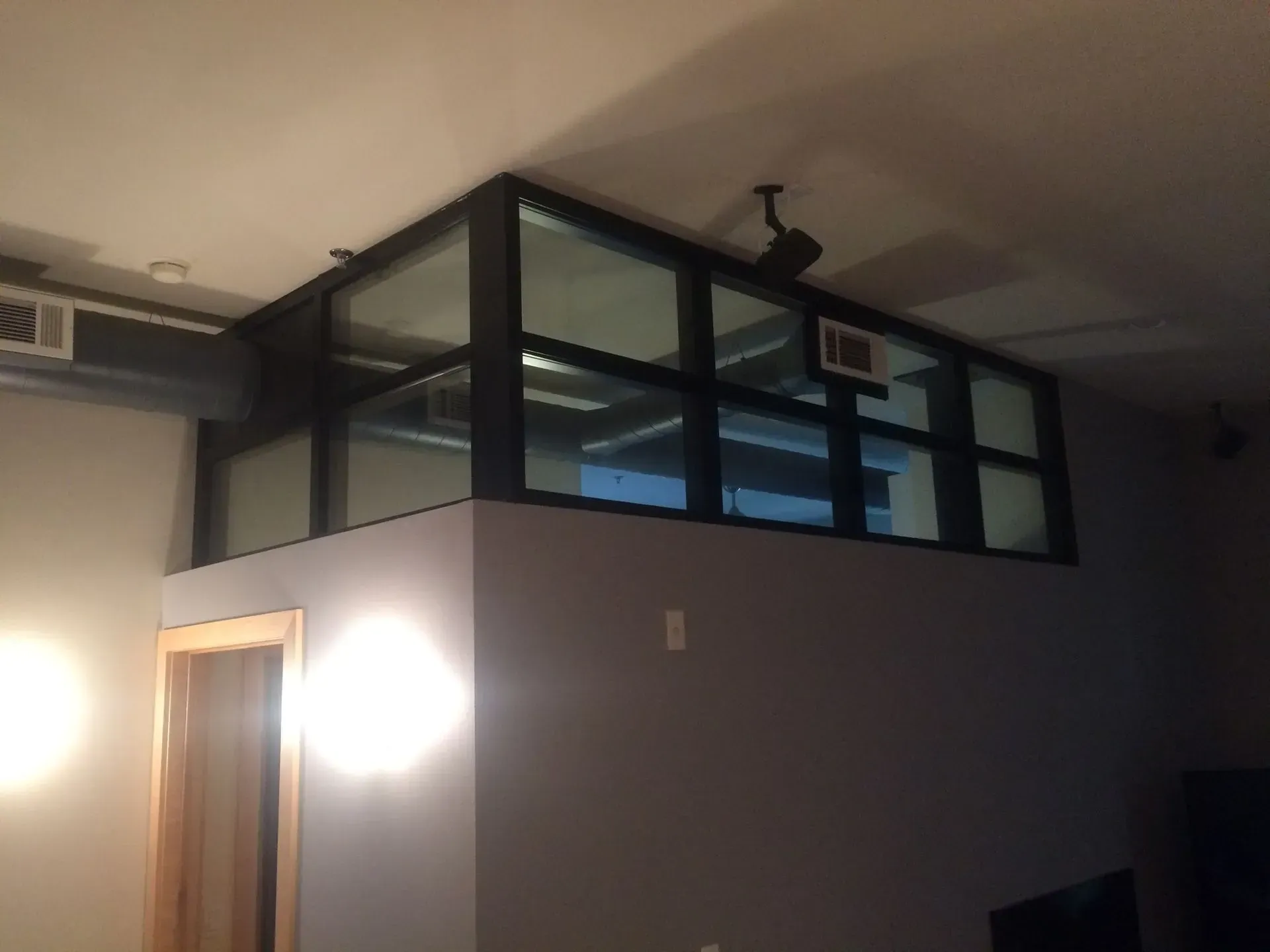 A room with a lot of windows and a ceiling fan