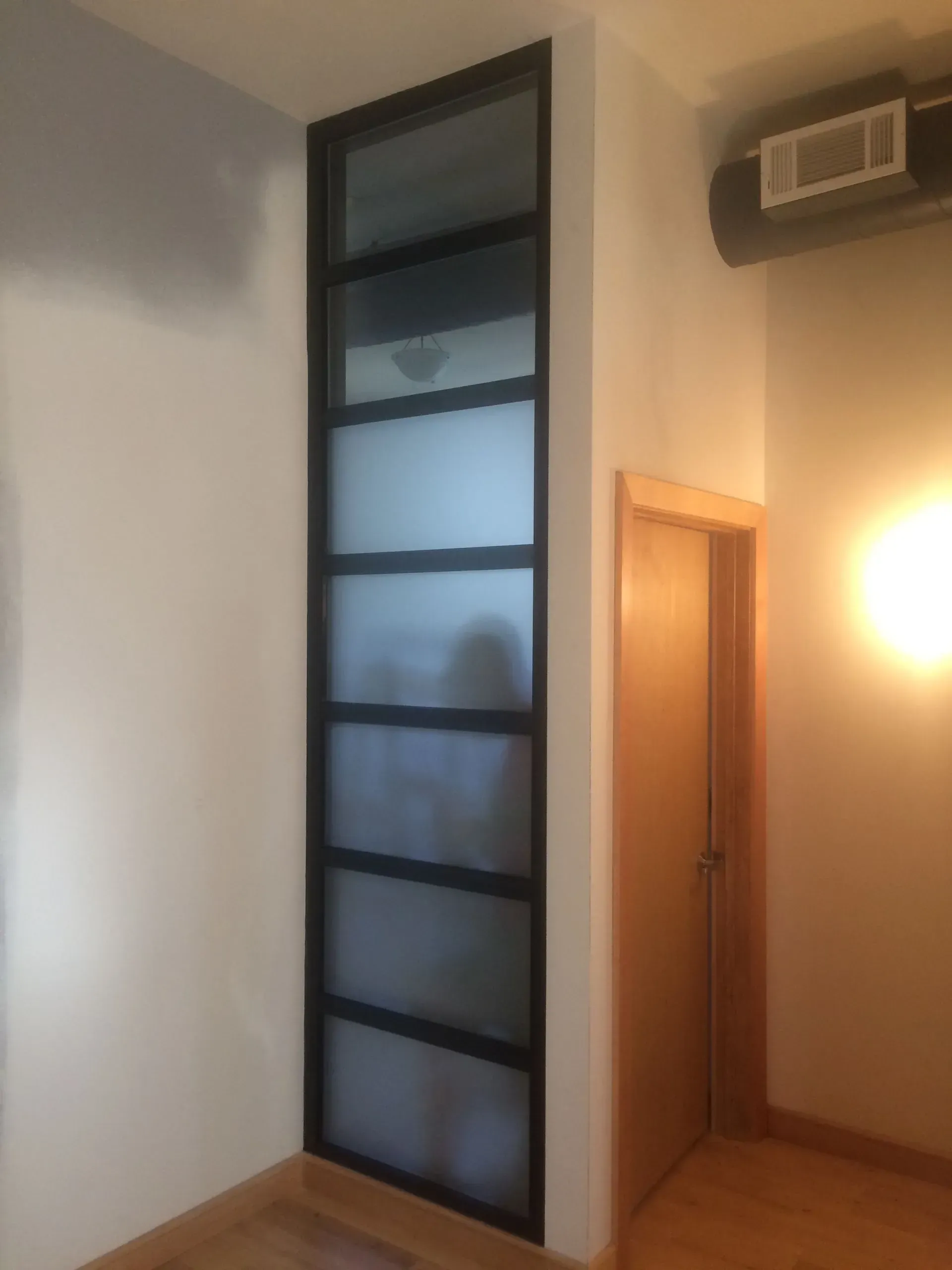 A room with a door and a sliding glass door