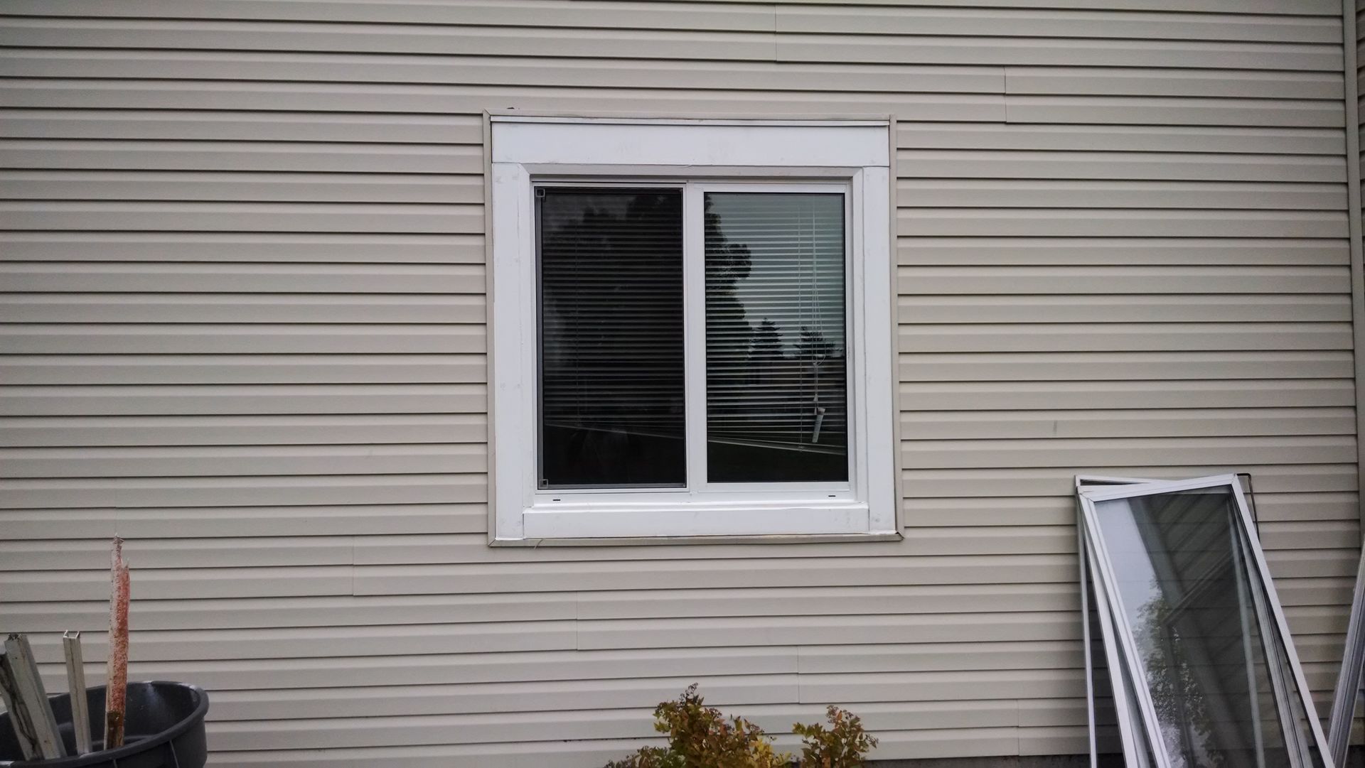 There is a window on the side of a house.