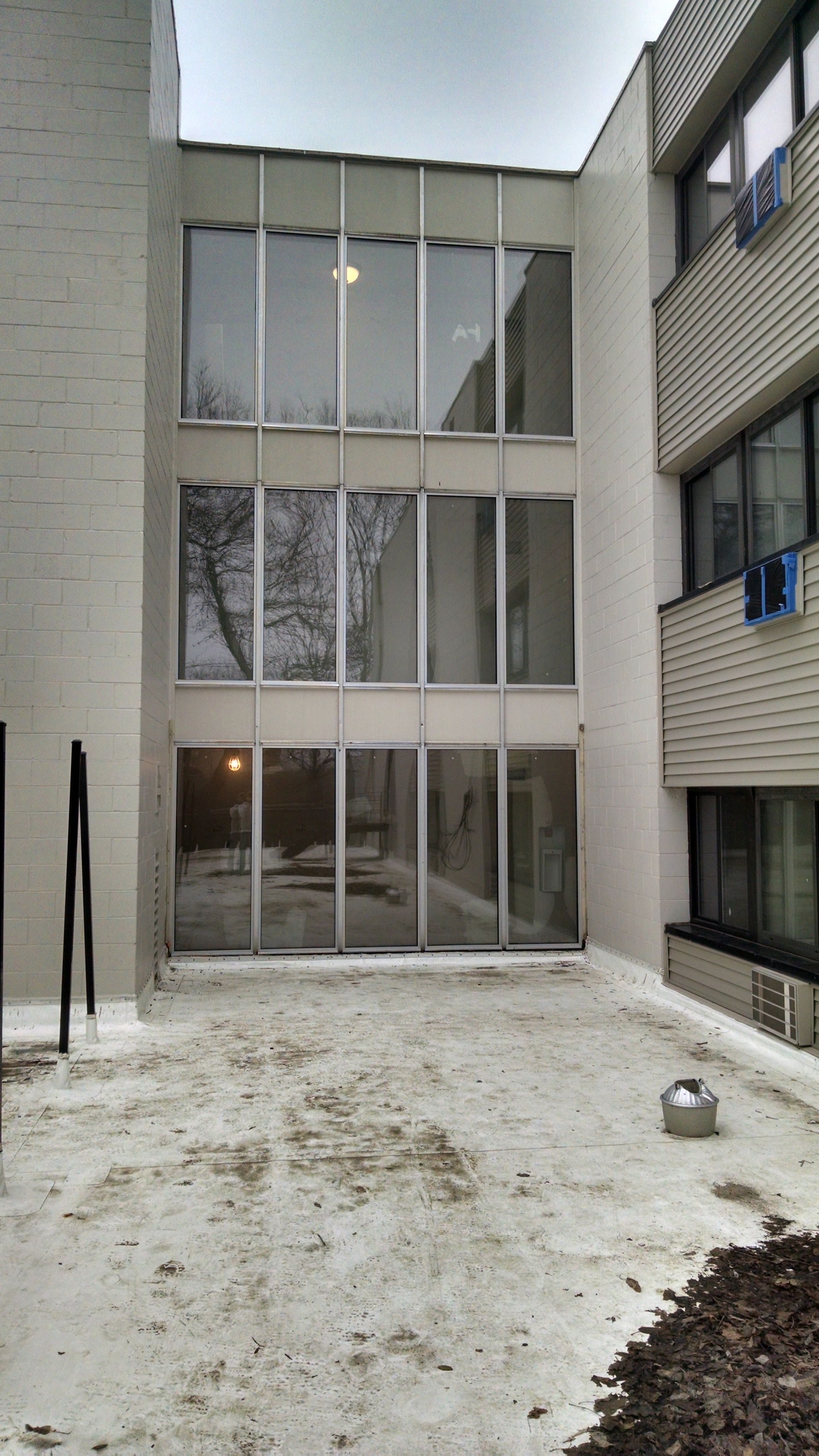 A large building with a lot of windows and a lot of snow on the ground
