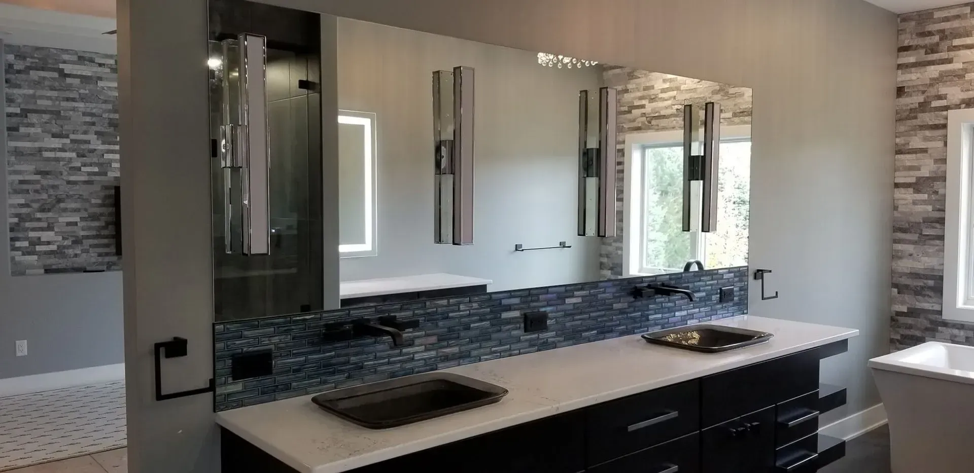 A bathroom with two sinks and two mirrors.