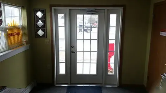 A white door with a lot of windows in a room.