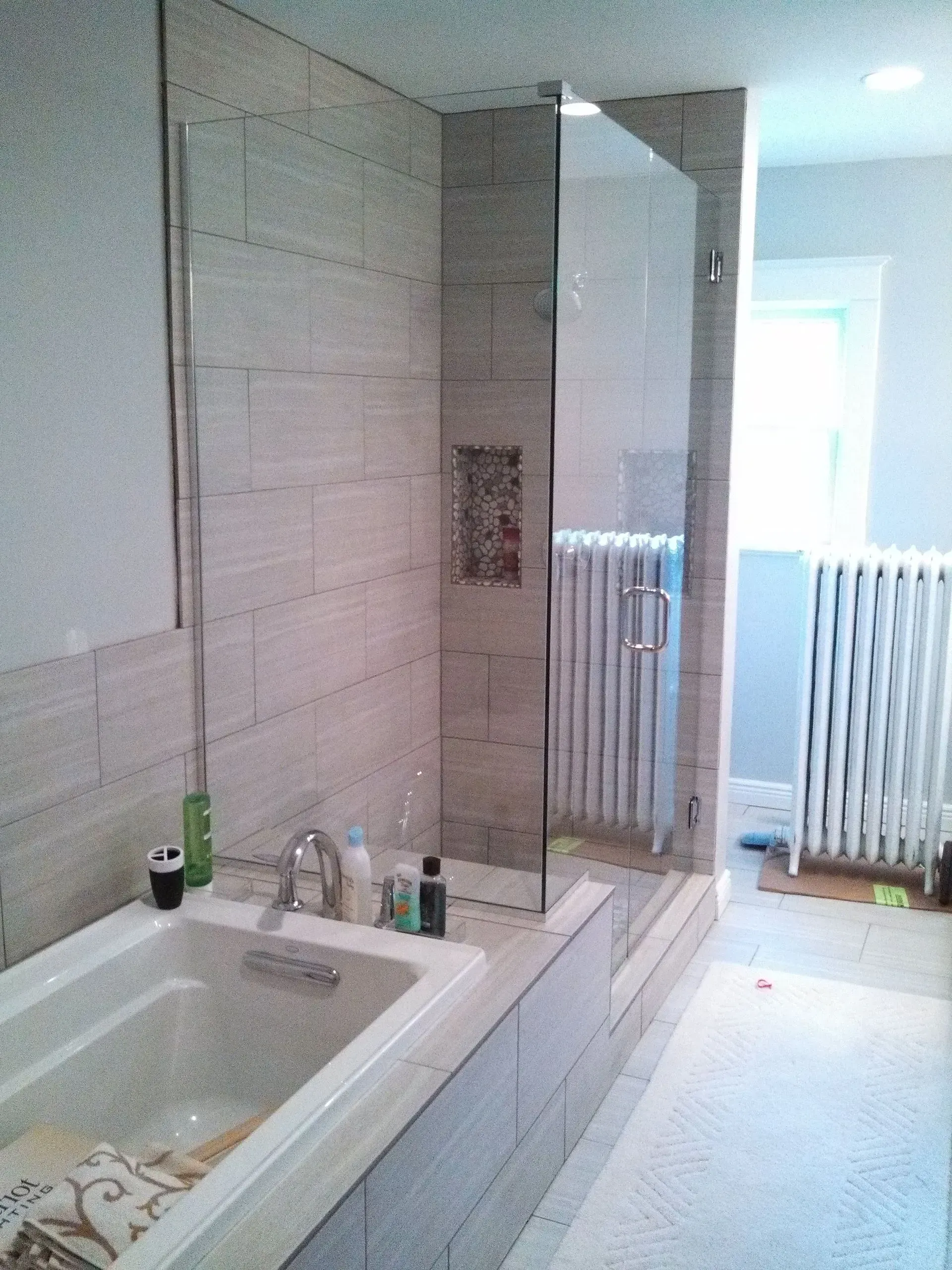 A bathroom with a bathtub and a walk in shower