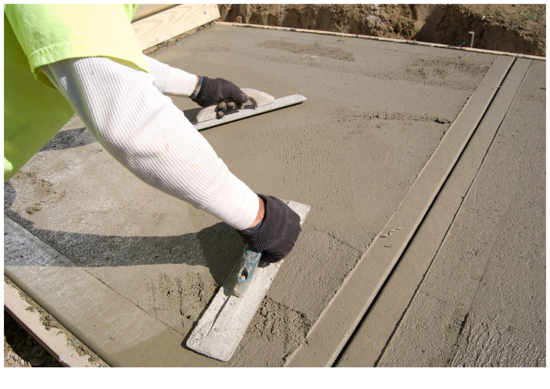 Person smoothing wet concrete with a hand float on a driveway slab