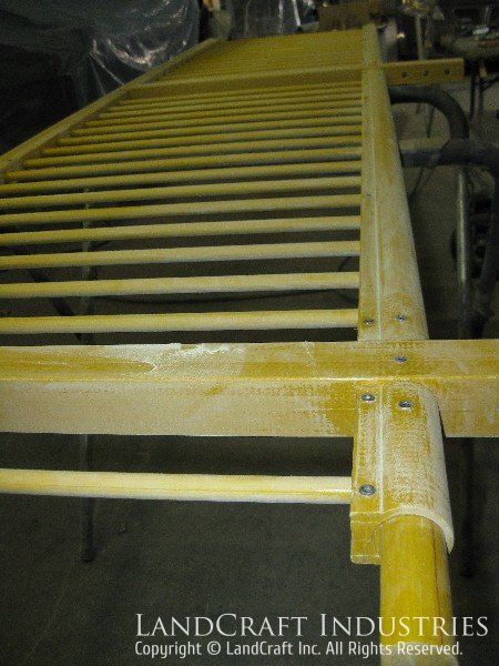 Fiberglass railing in the refinishing stage before installation
