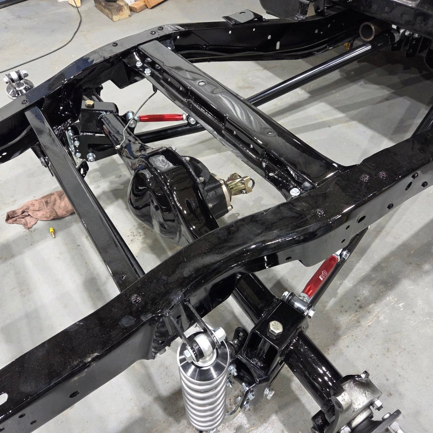 A black frame with a shock absorber attached to it