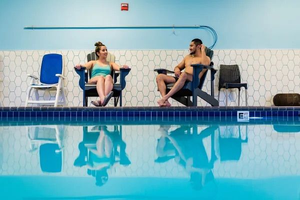 Couple having conversation in pool at River Inn at Seaside, OR