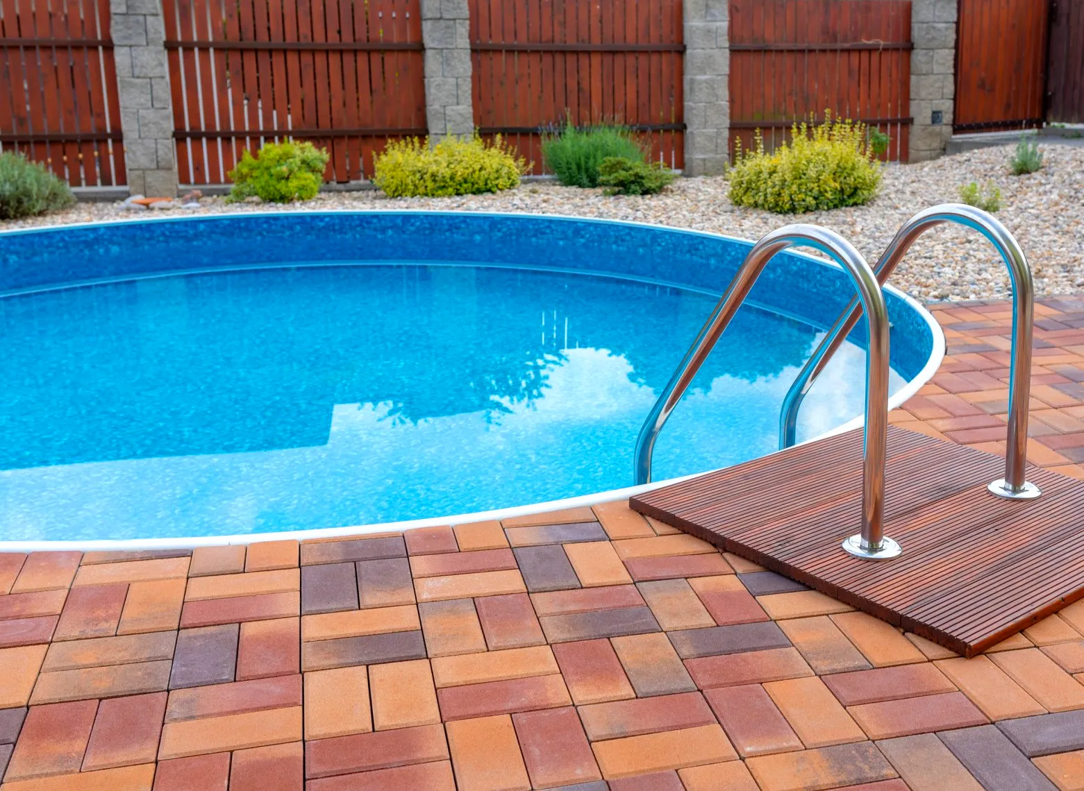 Pool opening of  recessed pool with brick stone deck