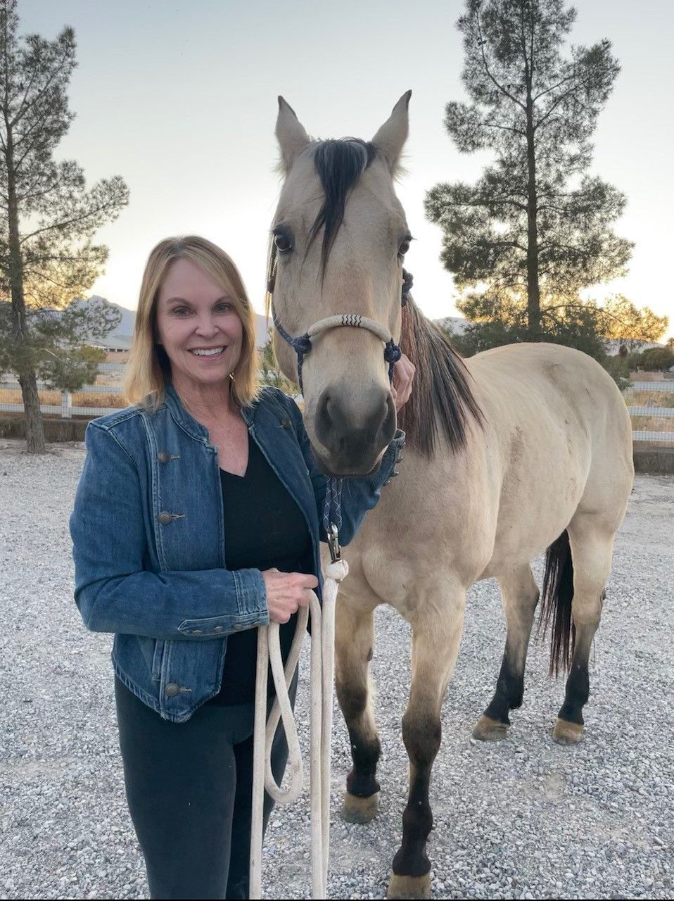 A man in a suit and tie is sitting in front of a window.