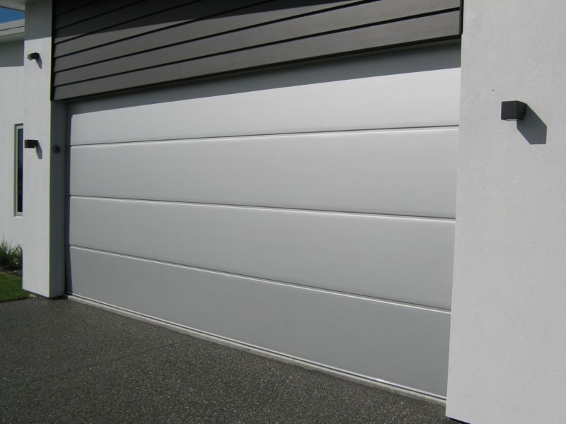 A white garage door with a black handle