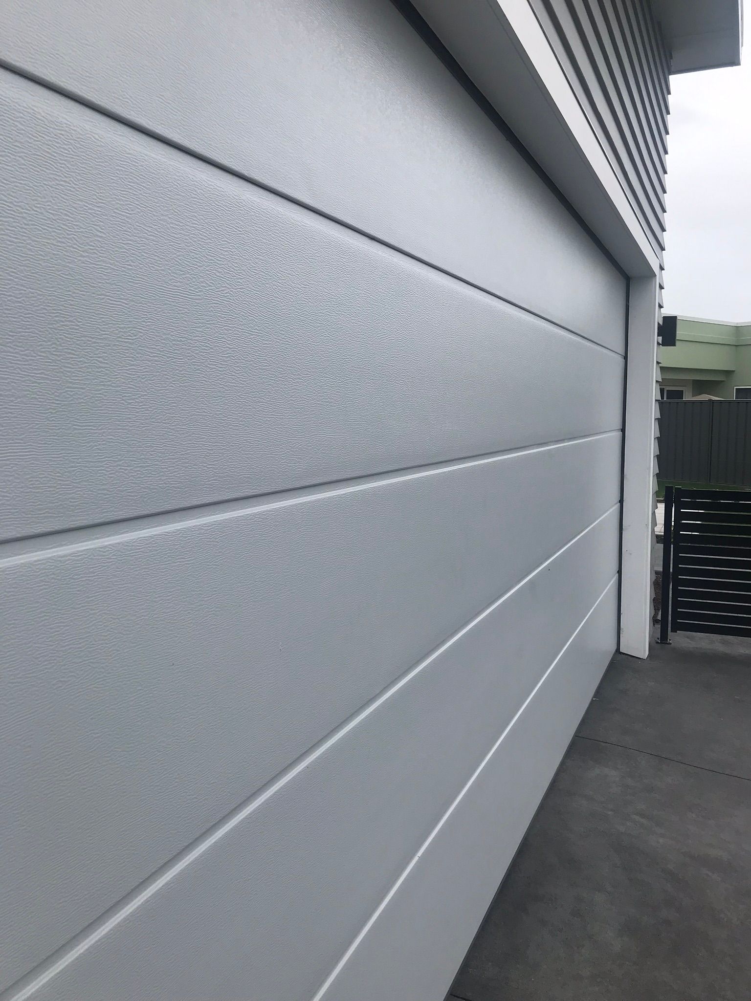 A close up of a white garage door on a building