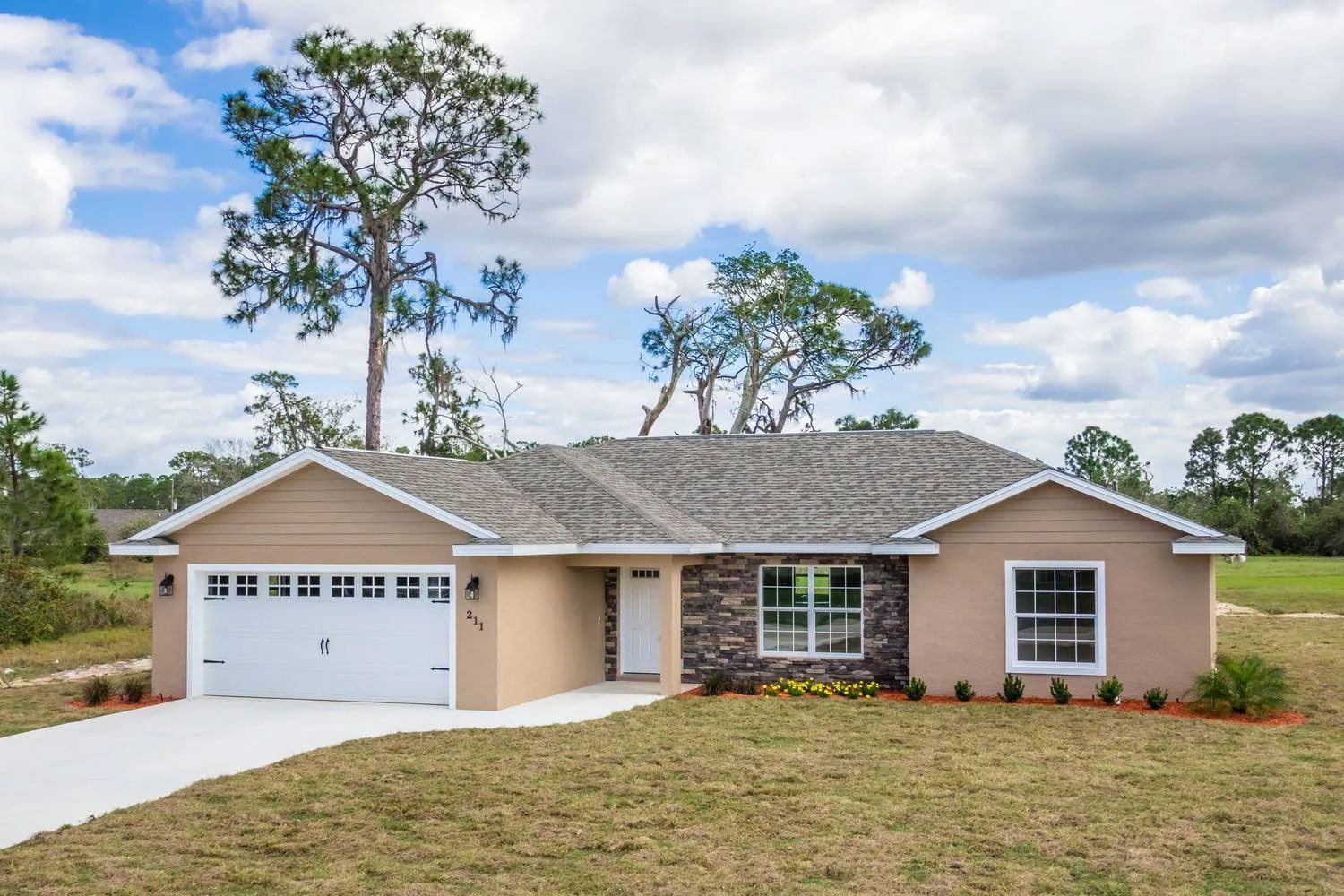 Home Featuring Stone Facade and Shingle Roofing Surface