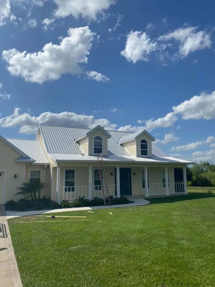 Local Home With Large Porch and Metal Roofing Surface