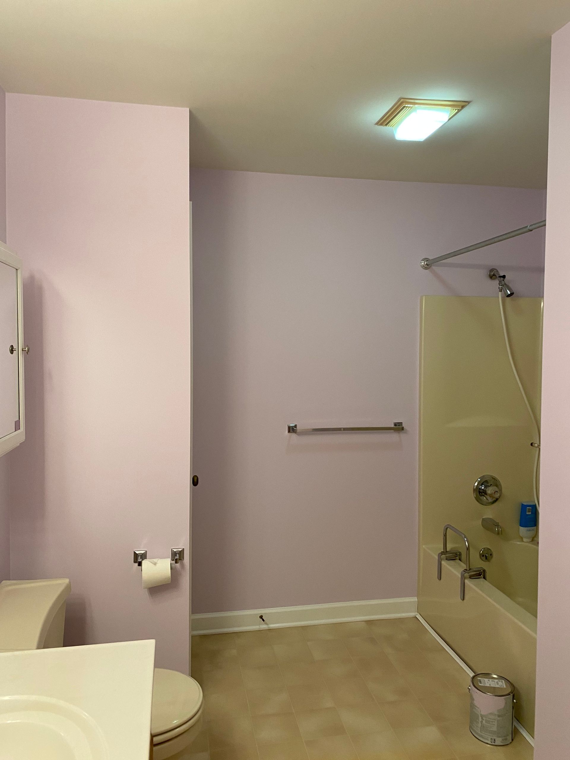 A bathroom with a toilet , sink , shower and bathtub.