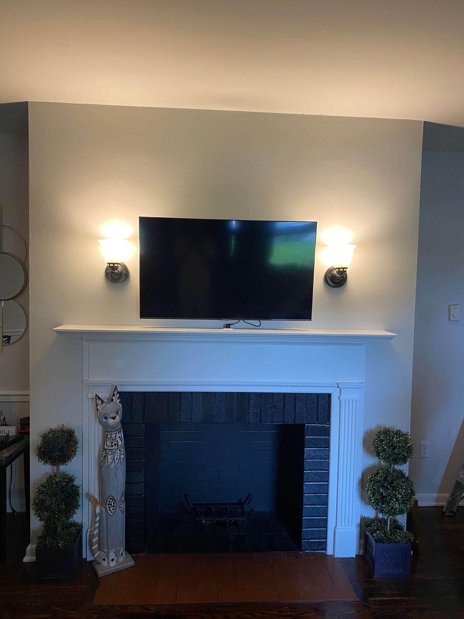 A living room with a fireplace and a flat screen tv above it.