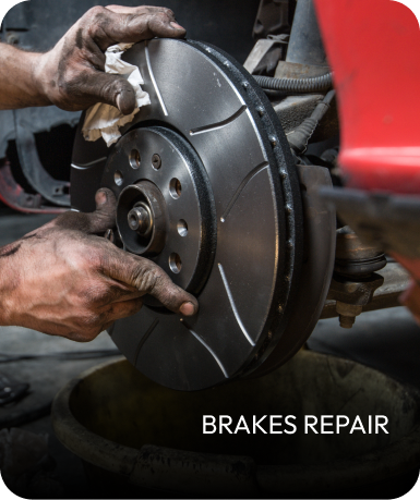 Mechanic repairing car brakes; hands are dirty; focus on brake rotor. | Mid Atlantic Autoworks