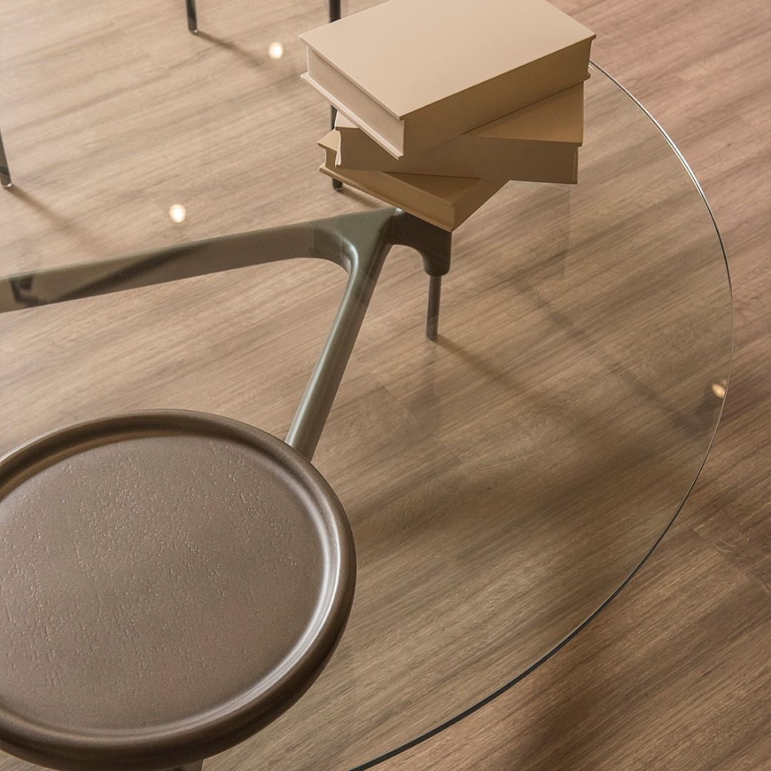 Uma mesa de centro de vidro com livros em cima