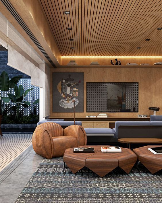 Uma sala de estar com sofá, cadeiras, mesas de centro e tapete.