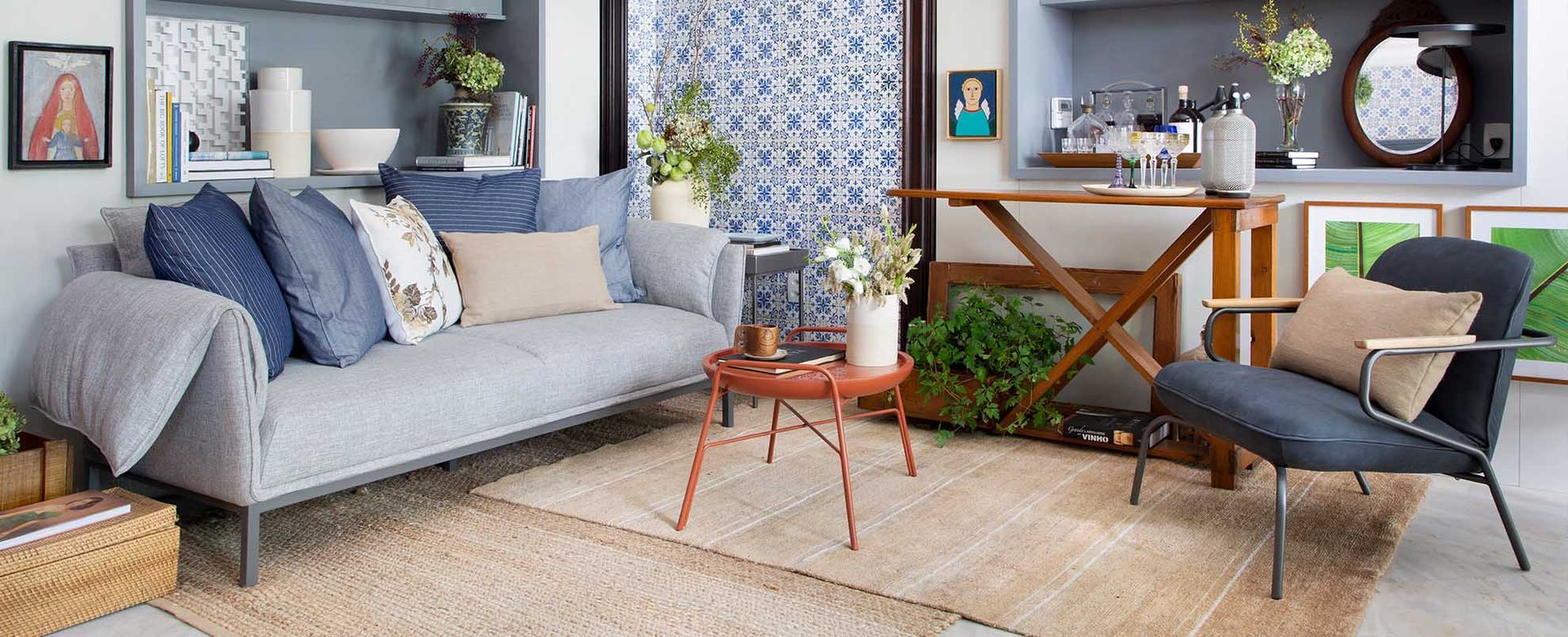 Uma sala com sofá, cadeira, mesa e tapete.