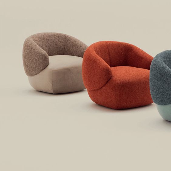 Três cadeiras de cores diferentes estão sentadas uma ao lado da outra