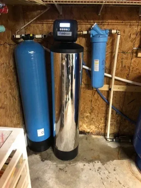 Two water tanks are sitting next to each other in a room.