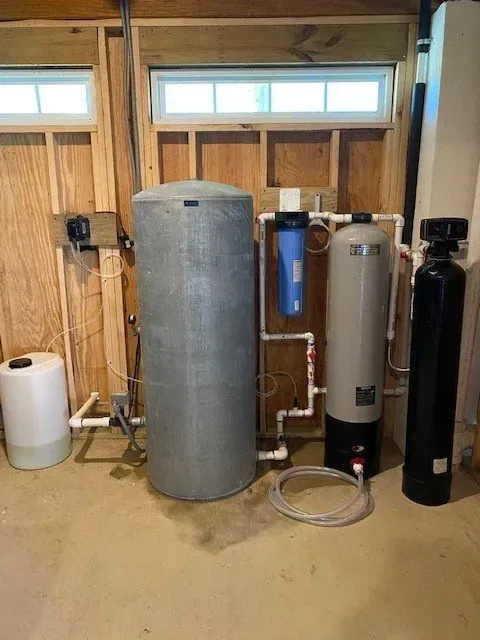 A water treatment system is being installed in a garage.