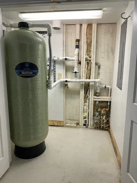 A large tank is sitting in a room next to a door.