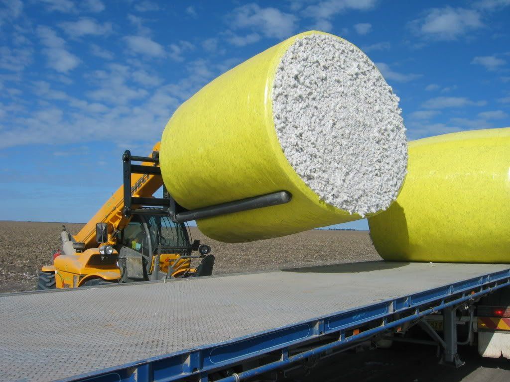 A photo of a Cotton Round Bale being loaded onto a truck using McCormack Cotton Bale Rollers