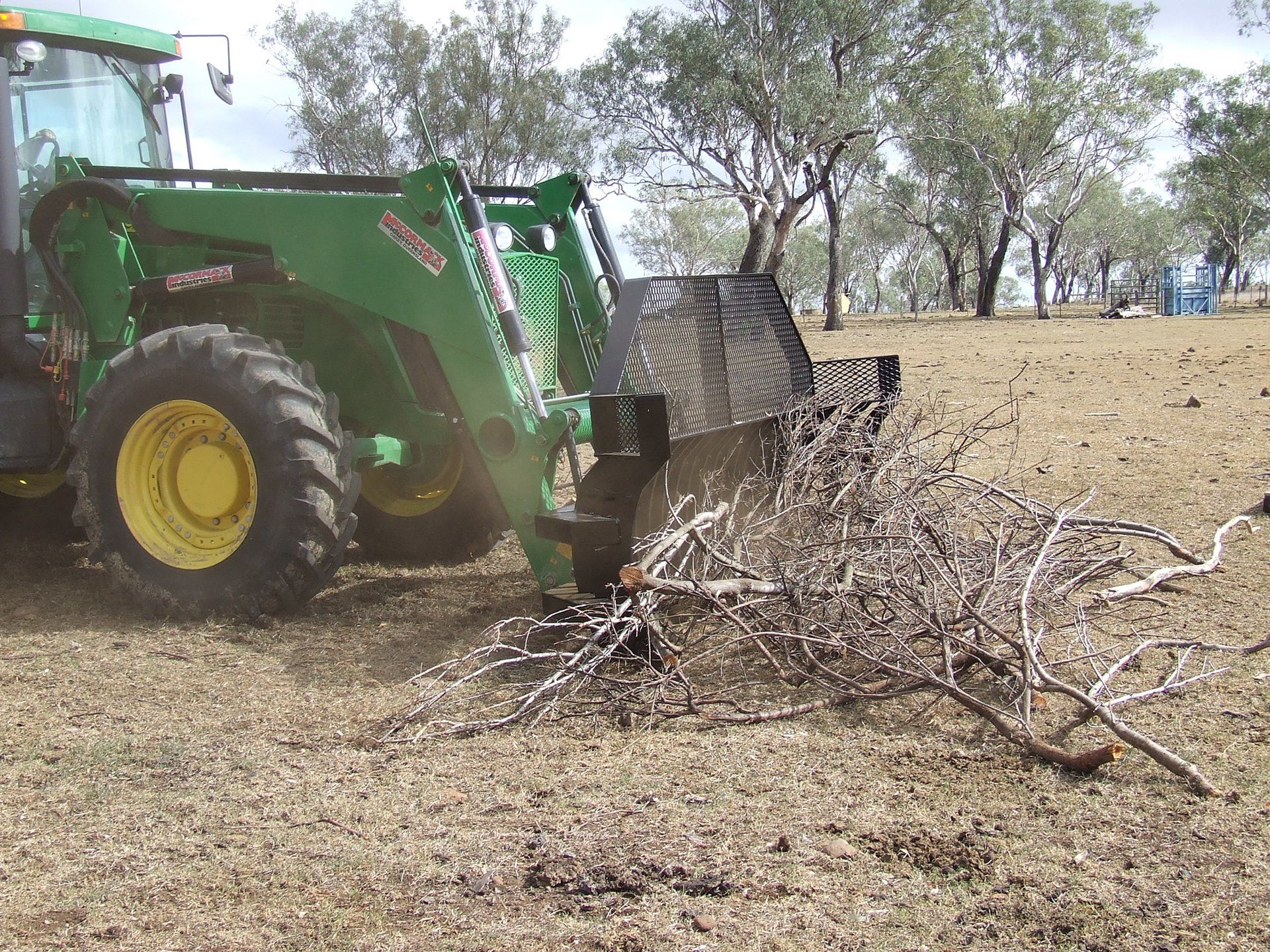 A photo of a McCormack Front End Loader Stick Rake Attachment in action