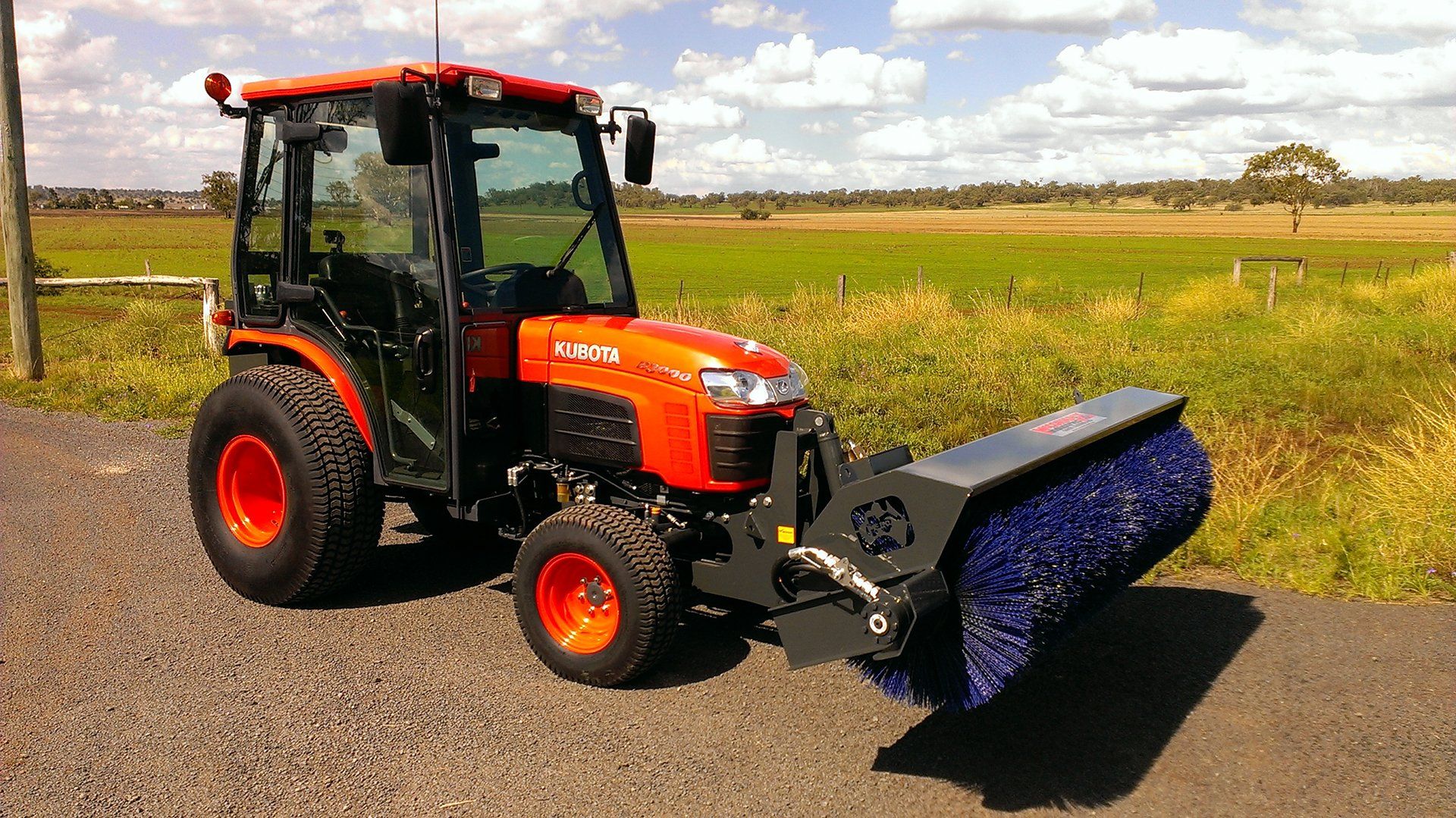 A photo of a McCormack Front Mounted Tractor Broom fitted to a Kubota tractor
