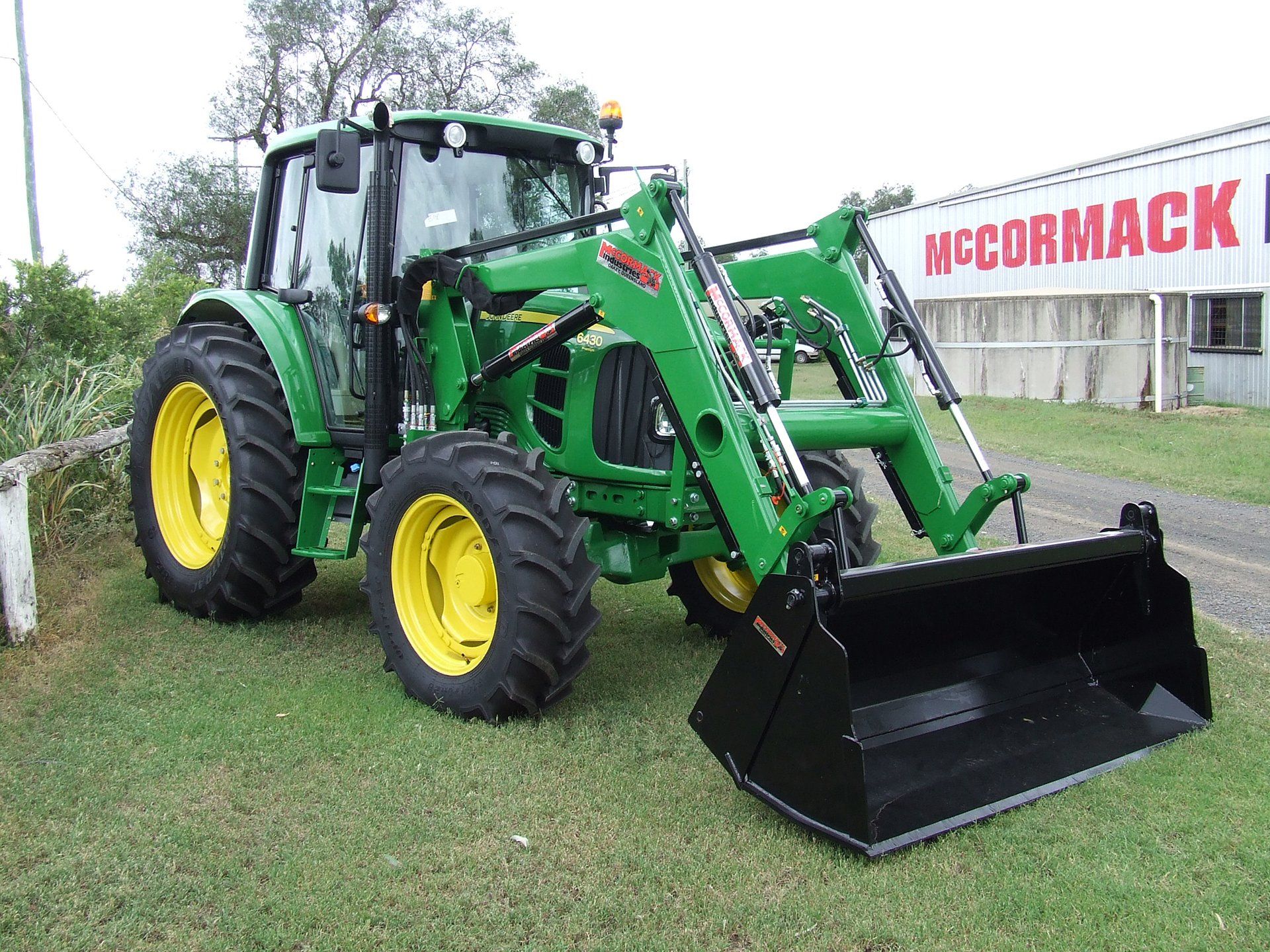 A McCormack Front End Loader with a Four In One Bucket attachment, fitted to a John Deere tractor