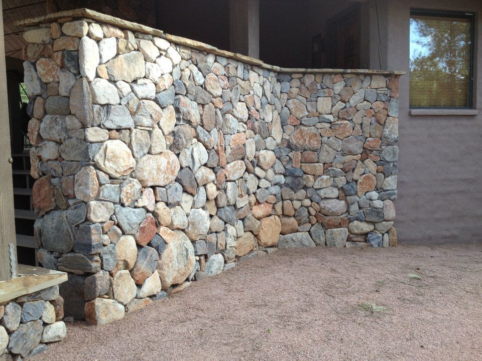 A stone wall with stairs leading up to it