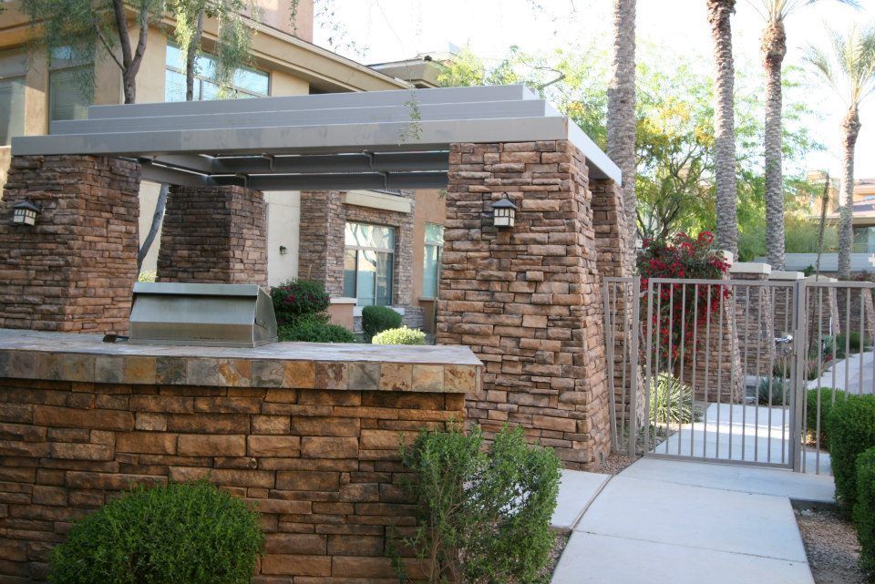 A brick wall with a grill in the middle of it