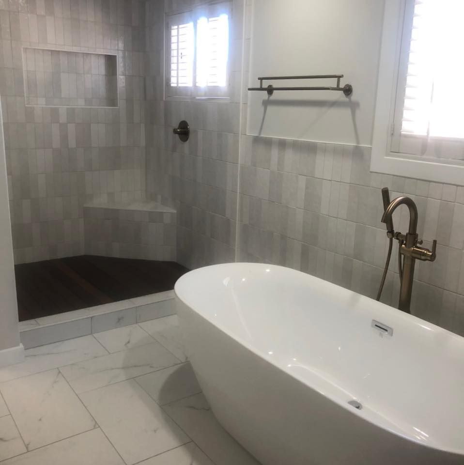 A bathroom with a bathtub and a shower.