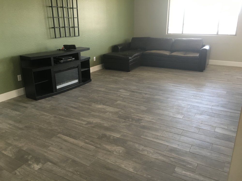 A living room with a couch and a fireplace.