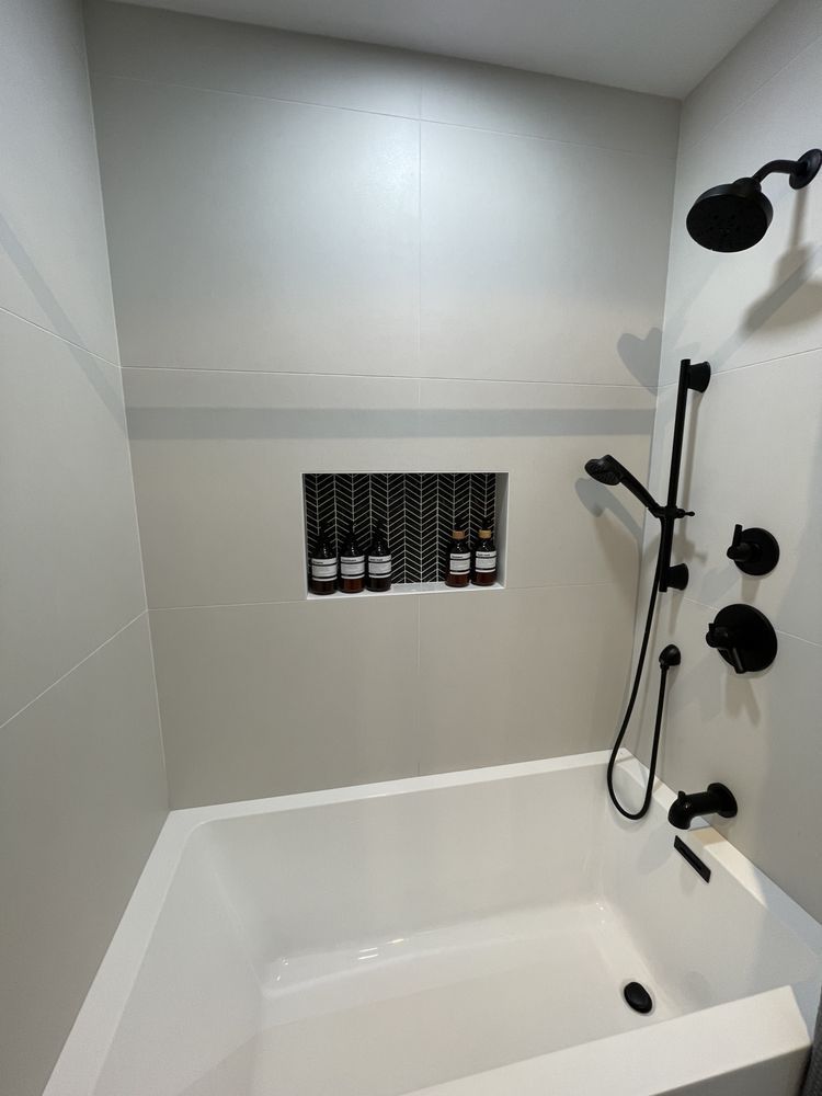 A bathroom with a bathtub and a shower.