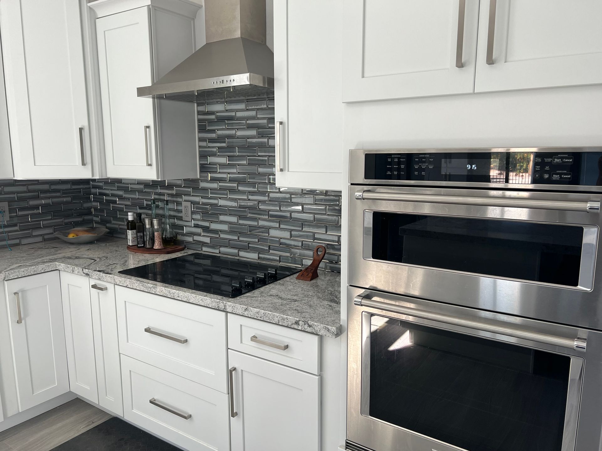 A kitchen with white cabinets and stainless steel appliances